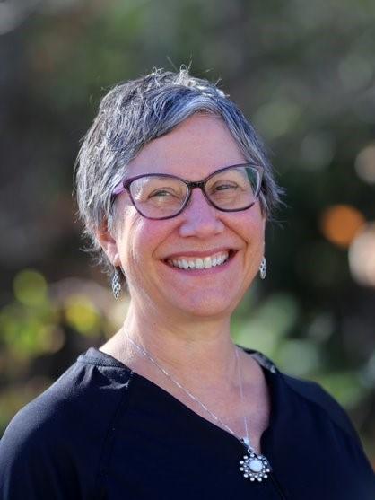Karen Volle is a woman with short grey hair, wearing glasses